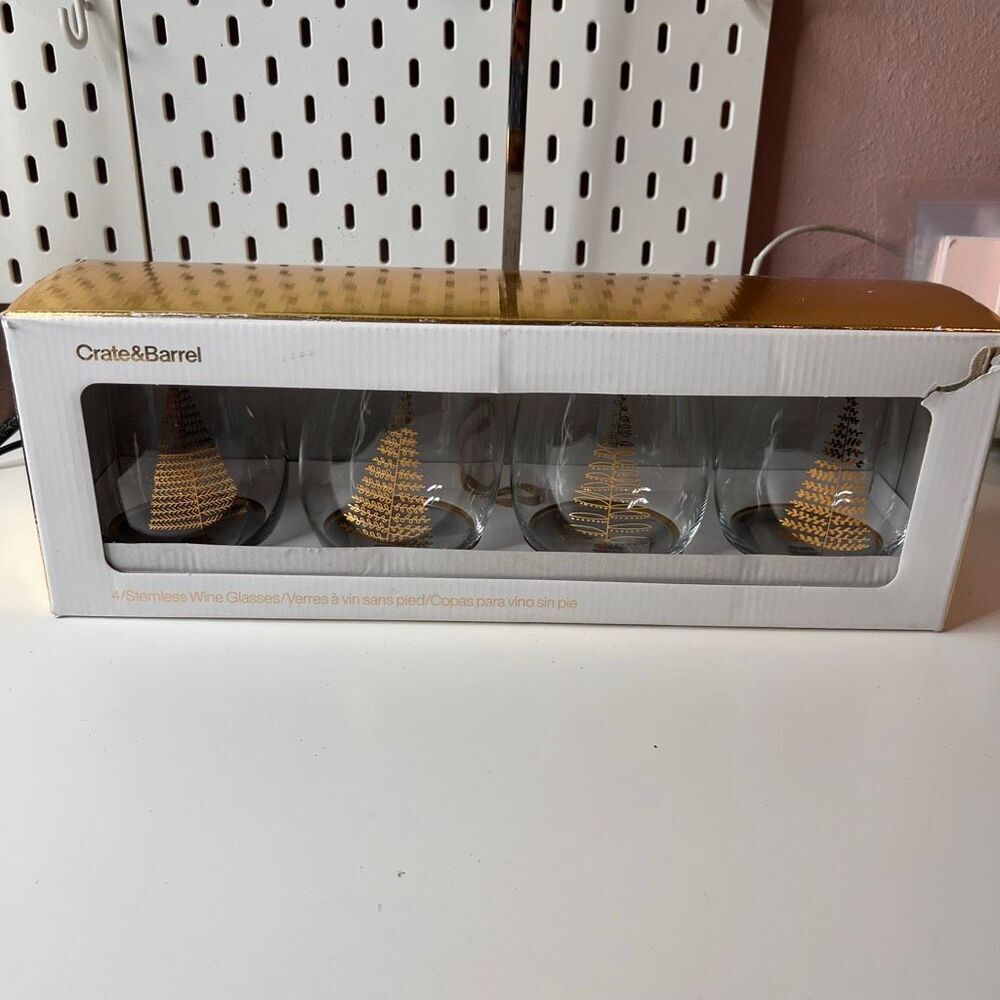 Crate & Barrel boxed set of 4 stemless wine glasses featuring a holiday tree des